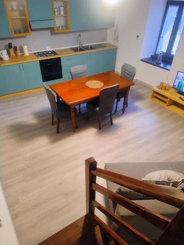 a kitchen with a wooden dining table and chairs at Cà d'Elsa in Pieve Vergonte