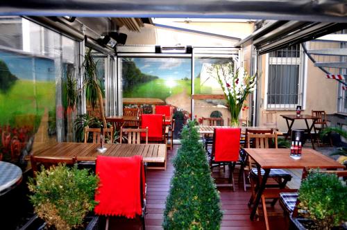 a patio with tables and chairs and a christmas tree at Hotel Prens Berlin in Berlin