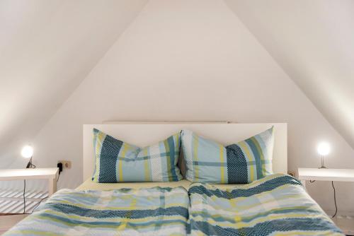 a bedroom with a bed with two pillows on it at Alte Seifensiederei 2 in Stralsund