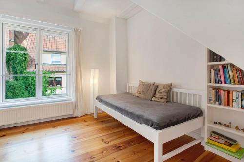 a bedroom with a bed and a book shelf at Alte Seifensiederei 2 in Stralsund
