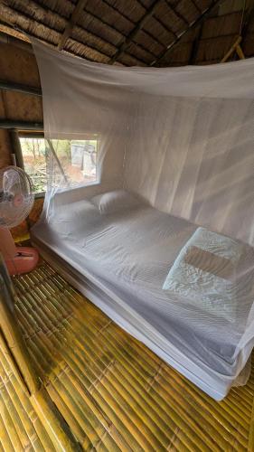 a bed in a bed frame in a room at Tarzan Bamboo hut in Khao Sok