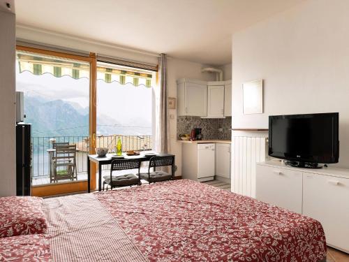 a bedroom with a bed and a kitchen with a balcony at Studio Für 2 Personen Ca 35 M Sup2 In Fonteno, Iseosee in Fonteno