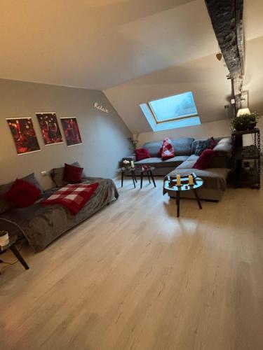a living room with a bed and a couch at Gite le Patis in Pré-en-Pail