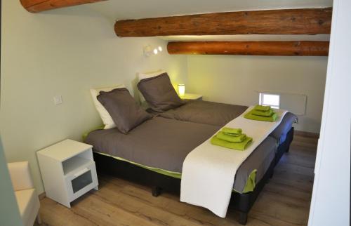 a bedroom with two beds with towels on them at Villa Pialats in Buis-les-Baronnies