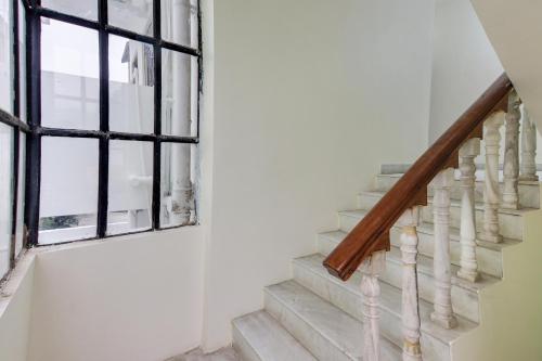 a staircase in a house with a window at SPOT ON Hotel Blue Moon in Nagpur