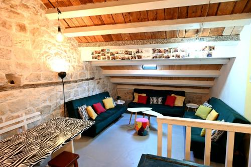 a living room with a couch and a table at White Rabbit Hostel in Hvar