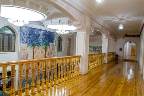 a hallway in a building with a mural on the wall at Shaherezada Boutique Hotel in Khiva