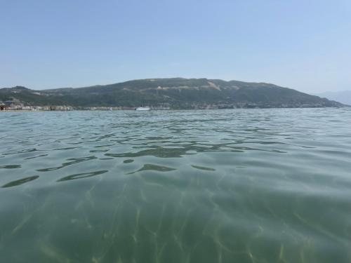 a large body of water with a mountain in the background at Queen Ekaterina II in Vlorë
