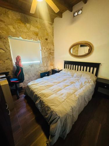 a bedroom with a large bed and a mirror at Casa En Acantilados Mar del Plata in Mar del Plata