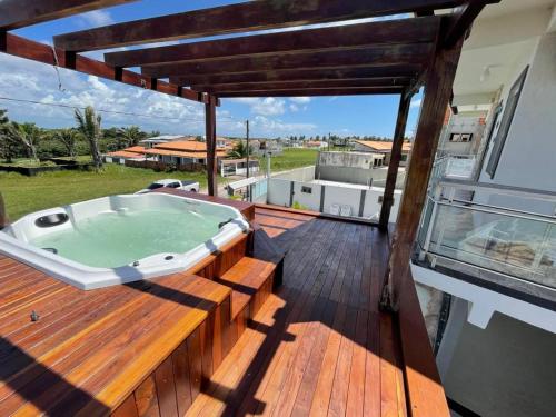 a hot tub on the deck of a house at Lazer Atalaia in Salinópolis