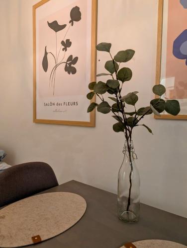 a vase with a plant in it on a table at 40-Apartment in Kemi city center , balcony and free parking in Kemi