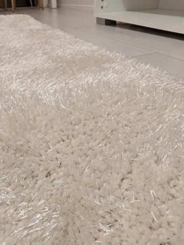 a white rug on the floor in a room at 40-Apartment in Kemi city center , balcony and free parking in Kemi