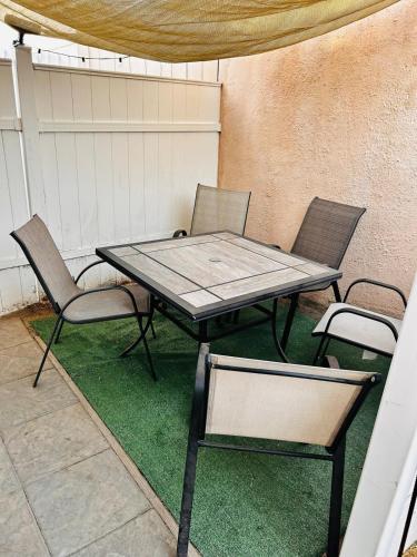 a table and two chairs on a patio at Cozy Serene Studio Backhouse w parking near it all in South Gate