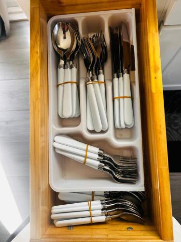 a drawer full of utensils in a wooden cabinet at Cozy Serene Studio Backhouse w parking near it all in South Gate