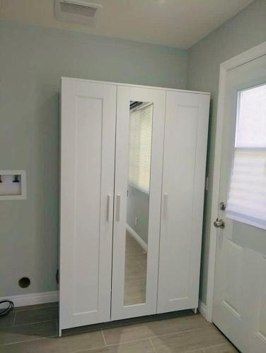 a white cabinet in a room with a window at Cozy Serene Studio Backhouse w parking near it all in South Gate