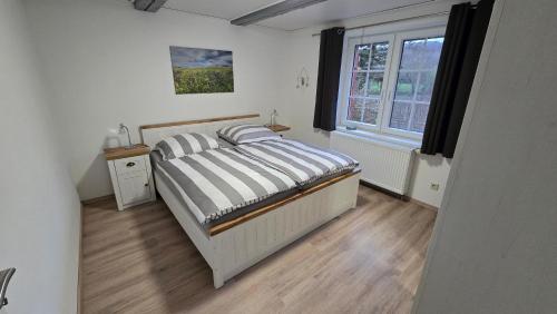 a bedroom with a bed and a window at Ferienwohnung Streckhofidylle in Osterode