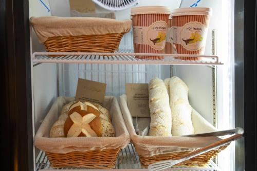 a refrigerator filled with lots of bread and drinks at Natural Deluxe Apartments Alpbach in Alpbach