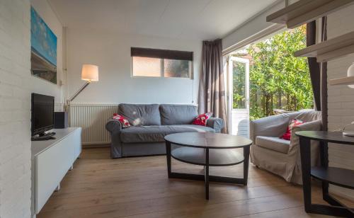 a living room with a couch and a table at Appartementen Domburg in Domburg