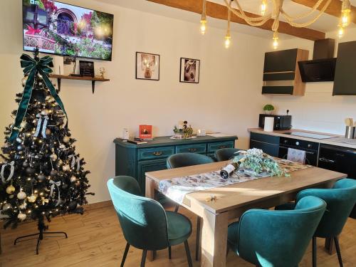 a kitchen with a christmas tree and a table at Gímes Apartman in Cserszegtomaj