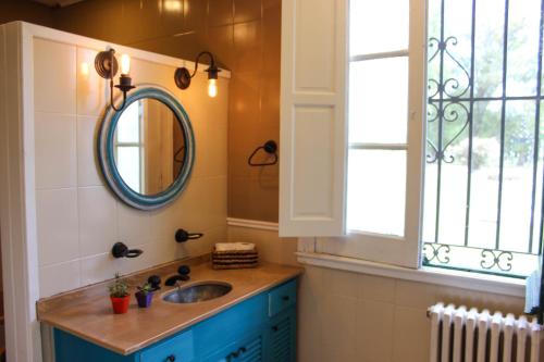 a bathroom with a sink and a mirror and a window at La Irene - Casa de Campo y Golf in Azul