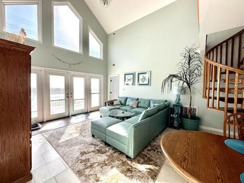 a living room with a couch and a table at Beautiful beach and bayfront house in North Topsail Beach