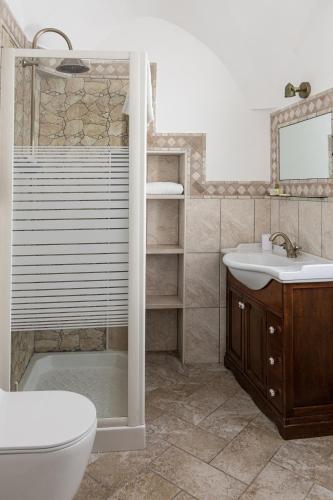 a bathroom with a toilet and a sink and a shower at La terrazza di Lillo in Carovigno