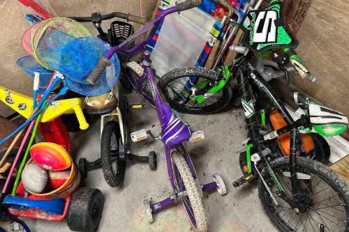 a group of childrens bikes and toys on the floor at Beautiful beach and bayfront house in North Topsail Beach