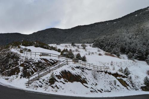 a snow covered mountain with a staircase on it at Hotel Parador de Canolich - Only Adults in Bixessarri