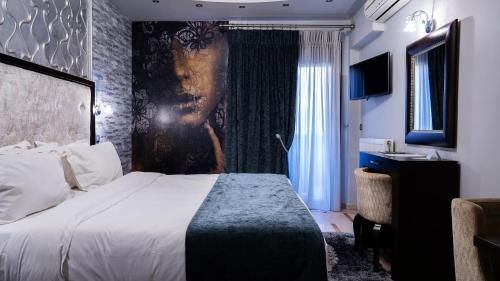 a hotel room with a bed and a window at Eliton Hotel & Spa in Kato Loutraki