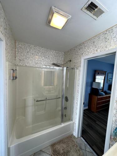 a bathroom with a shower and a tub at Beautiful beach and bayfront house in North Topsail Beach