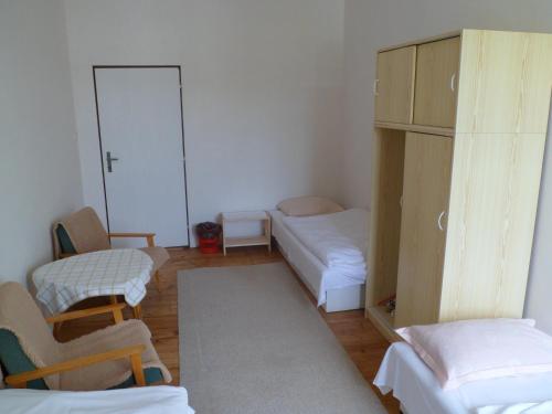 a room with two beds and a couch and a cabinet at Turistická ubytovna Podomí in Podomí