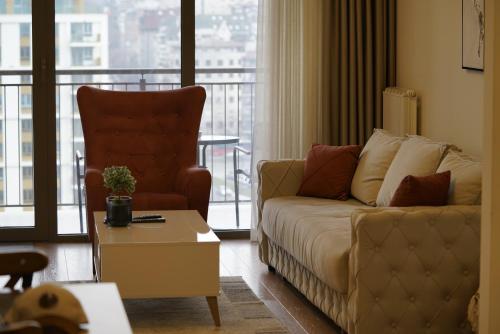 a living room with a couch and a view of a balcony at Best Apartments-Aqua-Belgrade Waterfront in Belgrade