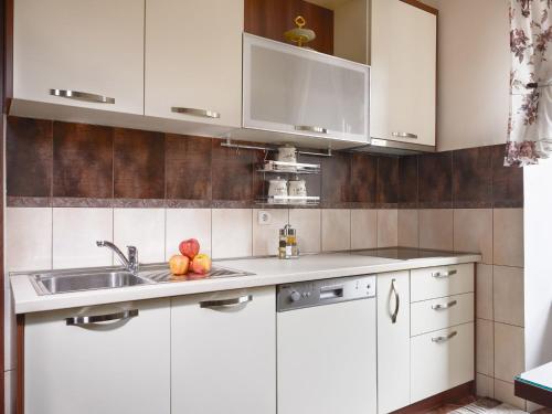 a kitchen with white cabinets and a sink at Apartment Palata Bizanti in Kotor