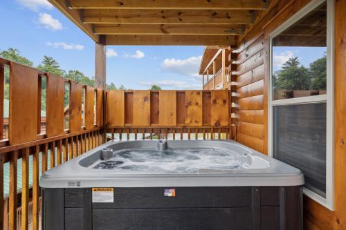 a jacuzzi tub on the deck of a house at Amazing Grace - Newly Built - 3 BR - Less Than 2 Miles from The Island in Pigeon Forge