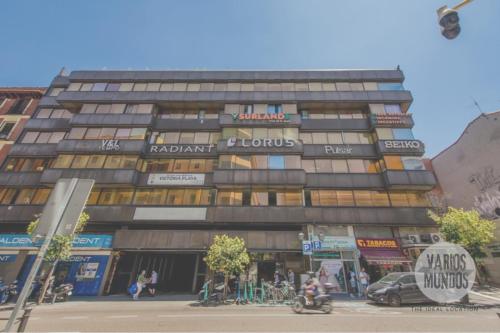a tall building on a city street with people in front at Malasaña a tus pies para 4, descubre San Bernardo 20 E3 in Madrid