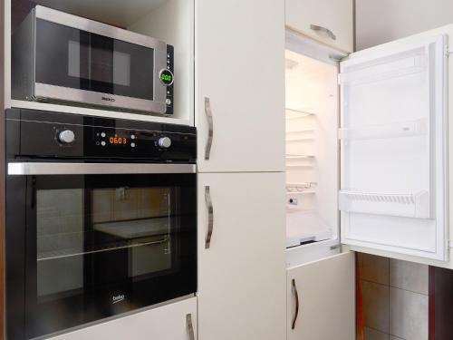 a kitchen with a microwave and a refrigerator at Apartment Palata Bizanti in Kotor