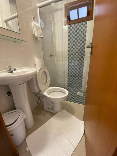 a bathroom with a toilet and a sink and a shower at Pousada Portal Sul in Florianópolis