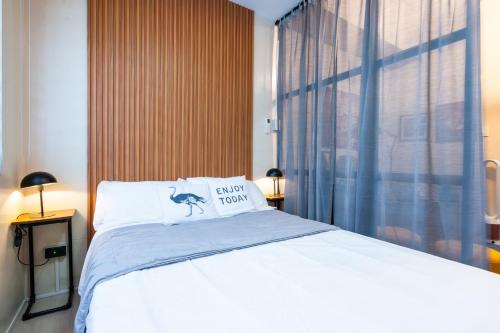 a bedroom with a bed with a pillow on it at Shell Residences Pasay 1BR Walk to MOA Newly Renovated! in Manila