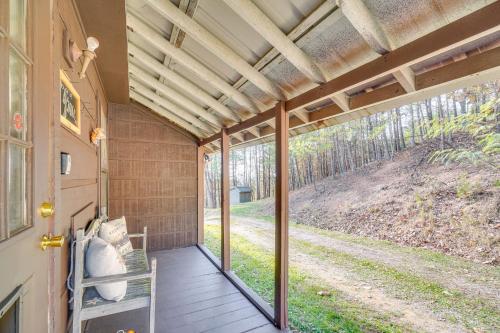 a screened porch with a view of a dirt road at Cabin with Deck and Mountain Views Near Gatlinburg! in Cosby