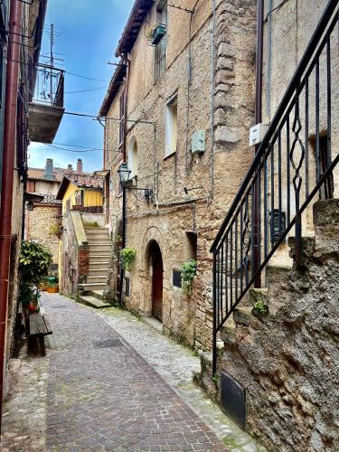 an alley in an old stone building with a staircase at A Casa du Manganu in Ponticelli