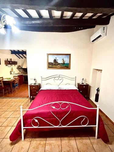 a bedroom with a bed with a red blanket at A Casa du Manganu in Ponticelli