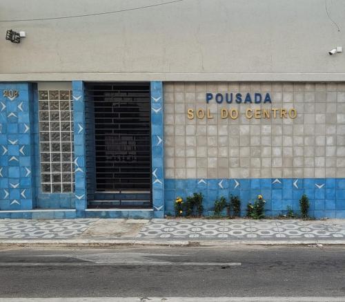 a blue and white building with a sell do centre at Sol do Centro Pousada in Fortaleza