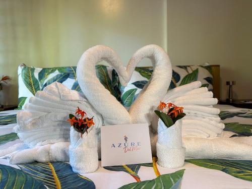 two swans are made out of towels on a bed at Azure Del Mar in Maya Beach