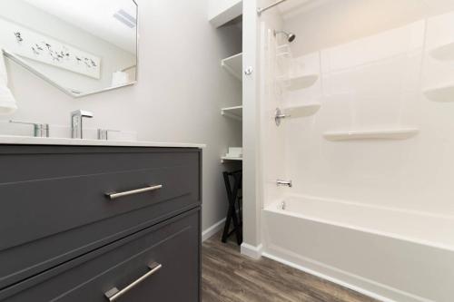 a bathroom with a sink and a mirror at Admiral's Retreat - iTrip Annapolis in Annapolis