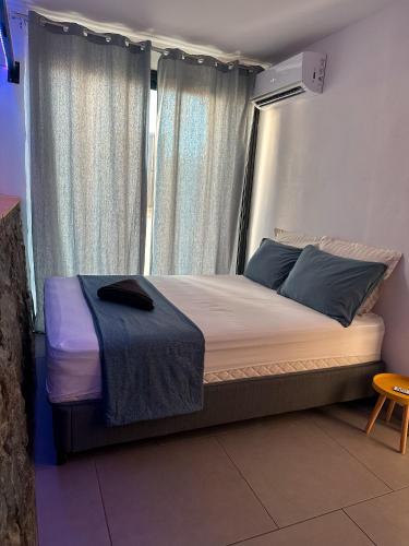 a bed sitting in a room with a window at Forecastle House in Saint-Louis