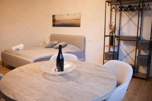 a room with a table with a bottle of wine on it at Ferienwohnung Studio LANA in Bad Zwischenahn