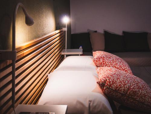 a bedroom with two beds and a head board at Old Town Nest in Civitavecchia in Civitavecchia