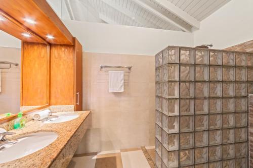 a bathroom with two sinks and a shower at Blue Bay Villa's in Blue Bay