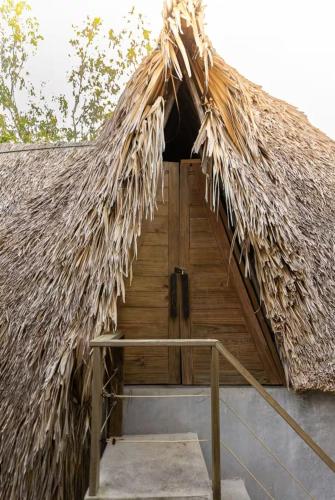 a thatched hut with a thatched roof at BarriOceano in El Paredón Buena Vista