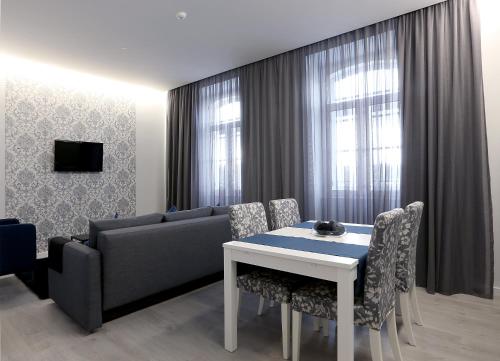 a living room with a couch and a table and chairs at Riversuites Apartments in Coimbra